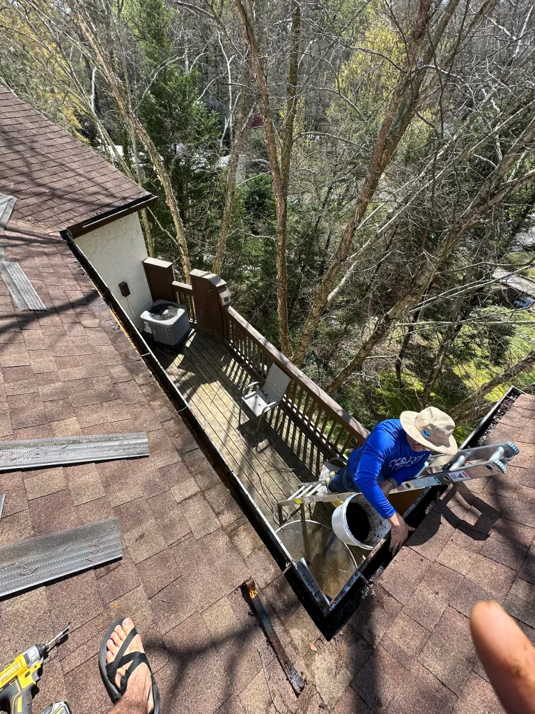 Hart Family Home Services - hand cleqaning a gutter